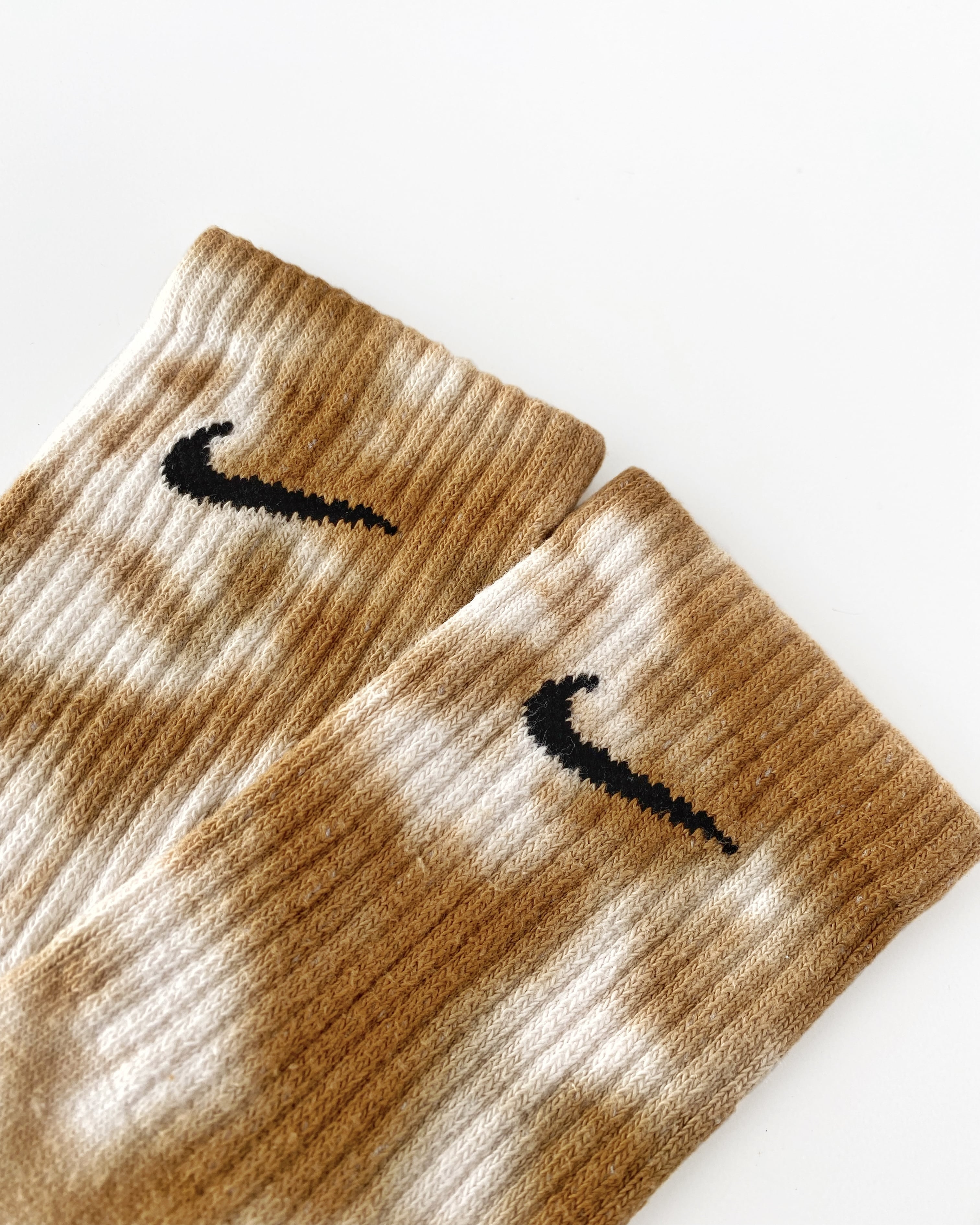 Mocha tie dye Nike socks with unique and colorful hand-dyed patterns.
