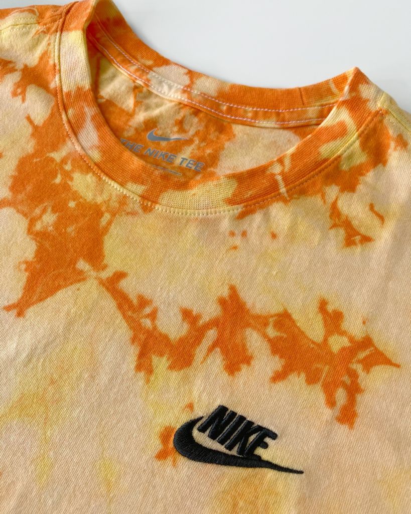 Vibrant Fanta mix colors tie dye on an authentic Nike tee.